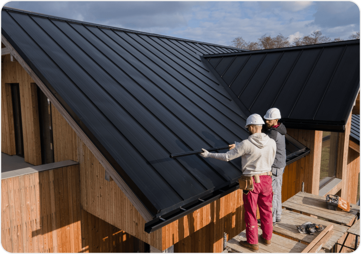 Roofers installing a metal roof