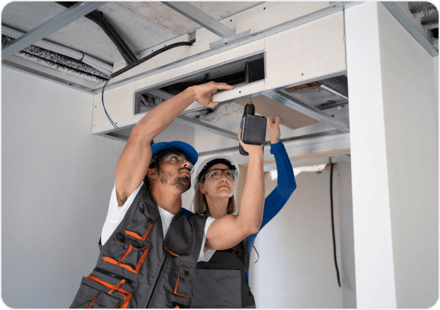 HVAC technicians working on a commercial unit